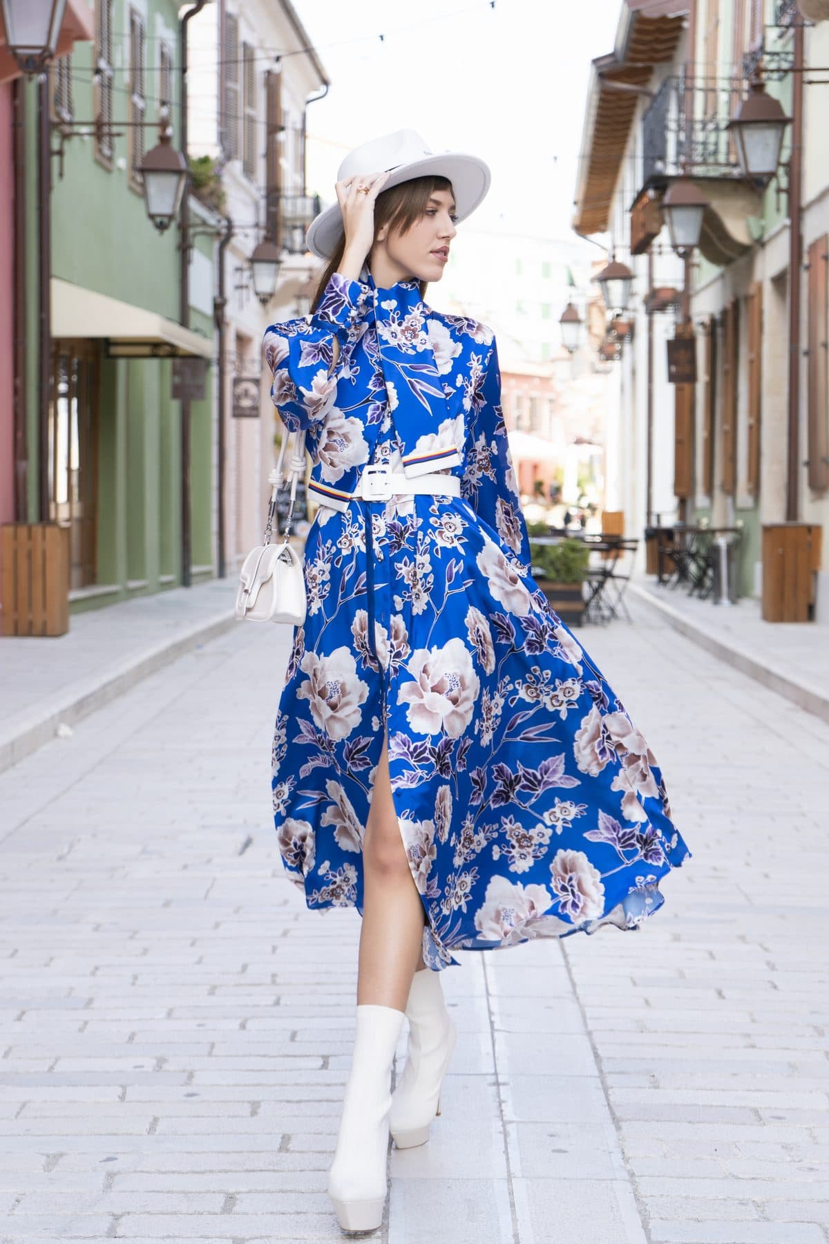 Blue floral dress in motion on a cobbled street
